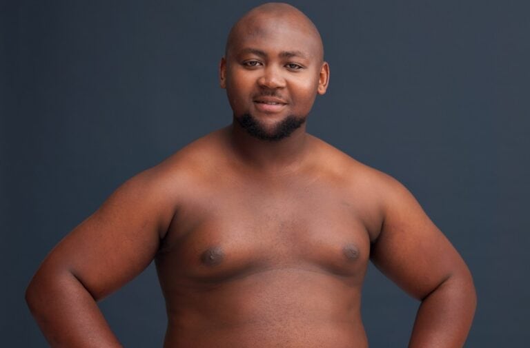 dark skinned man shirtless exposing fat chest
