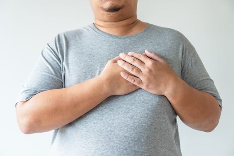 adult male with hands on chest