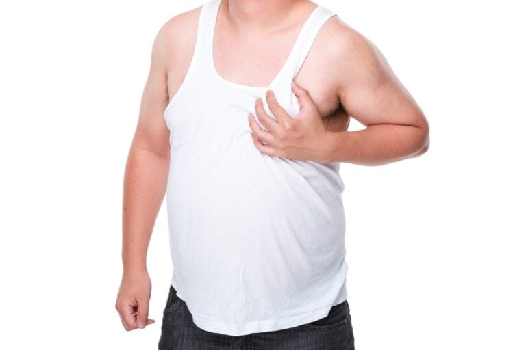 man in sando holding chest