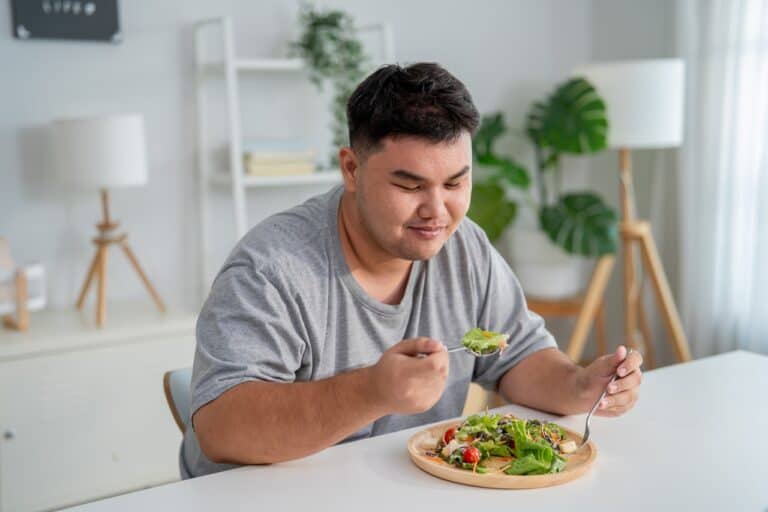 fat man eating salad