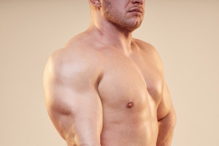 close up of man's massive arms and chest