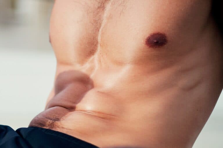male with gyno in black shorts