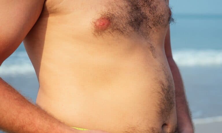 close up of man's chest area in beach background